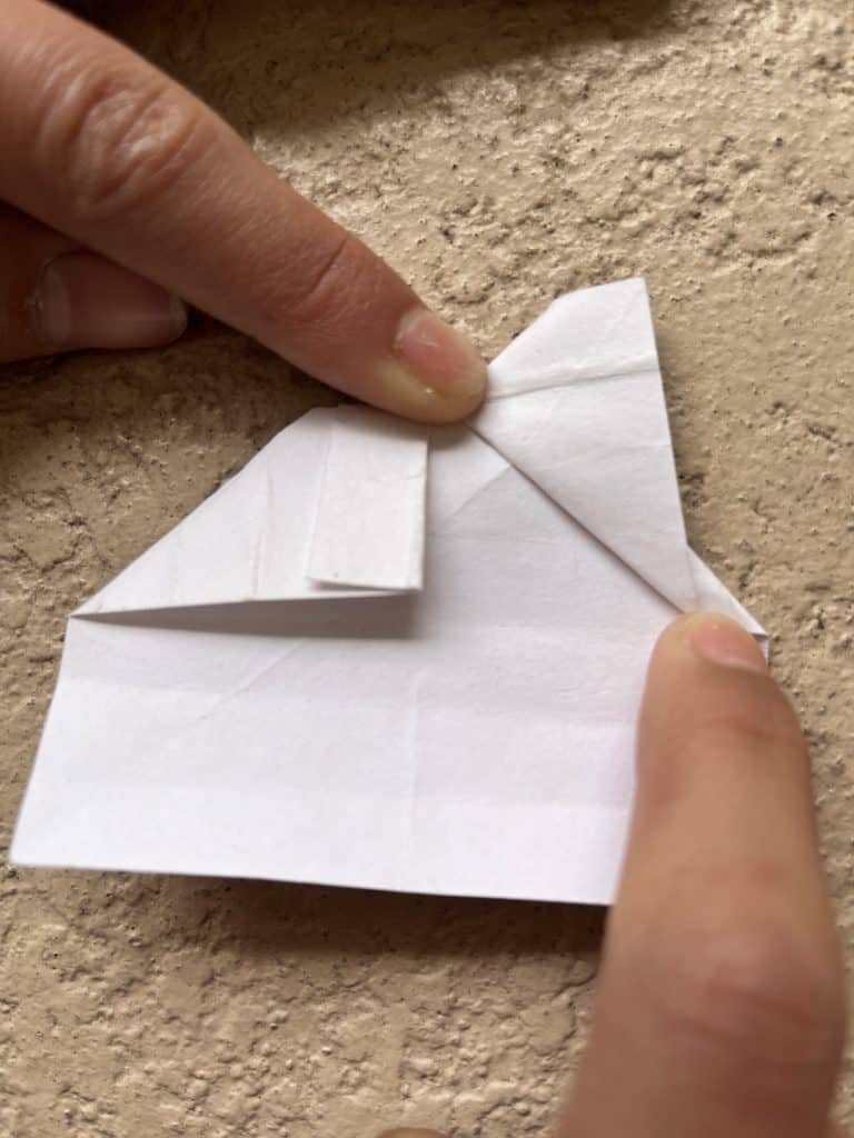 Flipped over and up squashed one side of paper. Making top of the heart in the origami heart ring.