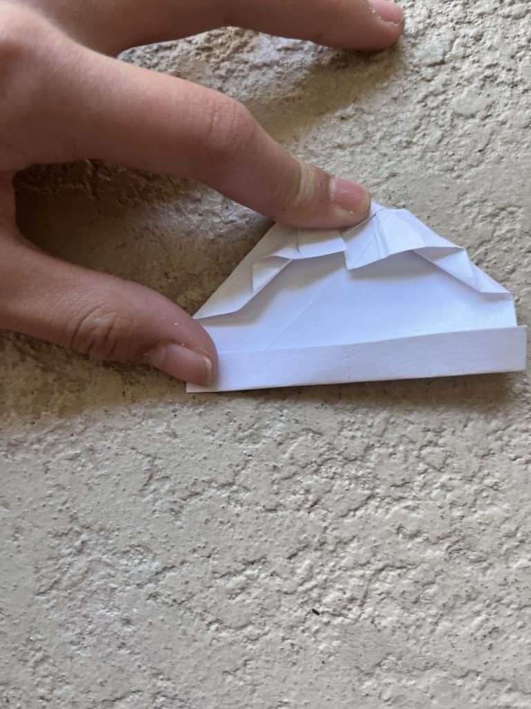 Folding up 1/8 paper to make band of origami heart ring.