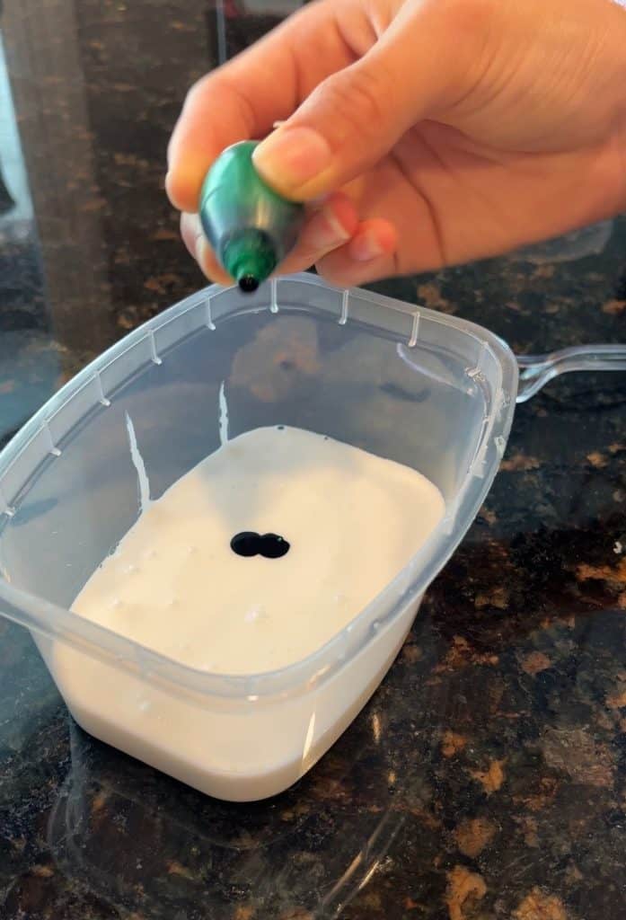glue with food coloring being added